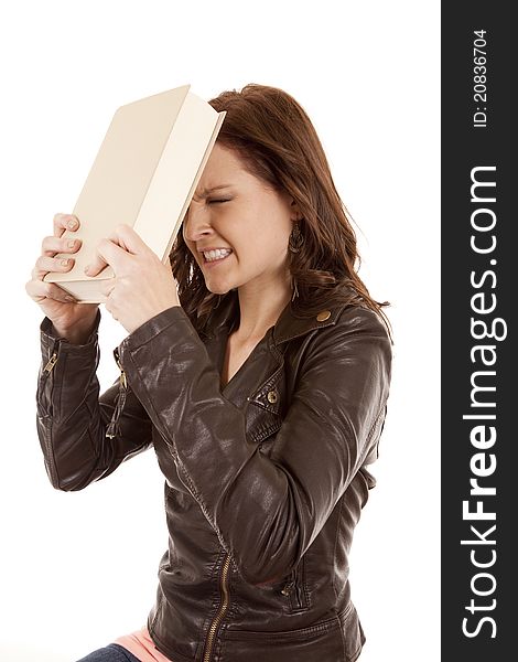 Woman slamming book against head