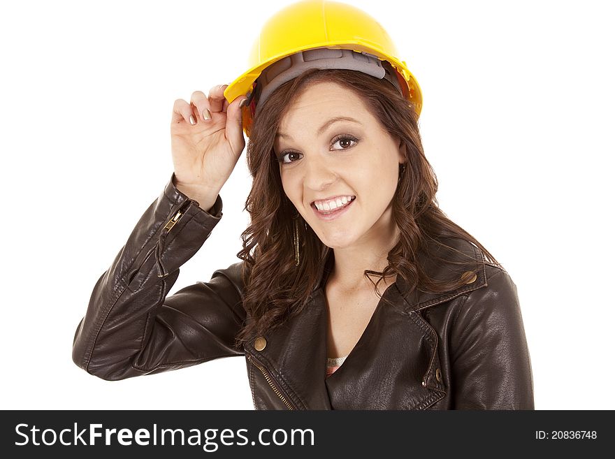 A construction woman touching the rim of her hard hat. A construction woman touching the rim of her hard hat.