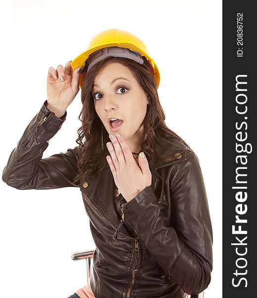 A woman in her yellow construction hat with a shocked expression on her face. A woman in her yellow construction hat with a shocked expression on her face.