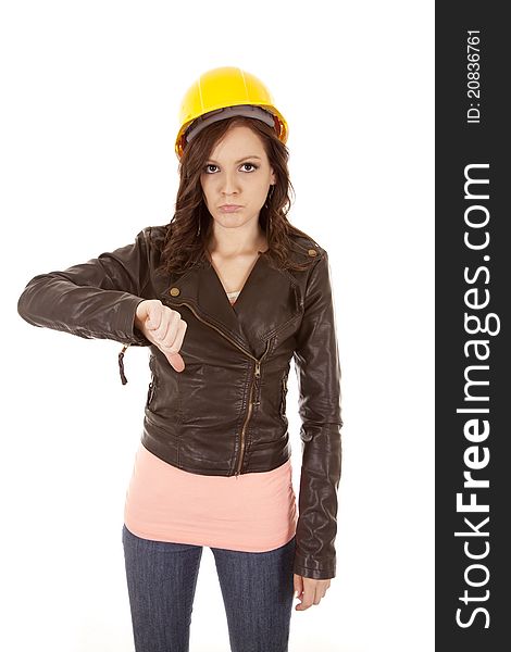 A woman in her yellow hard hat not liking what she sees with her thumb pointing down. A woman in her yellow hard hat not liking what she sees with her thumb pointing down.