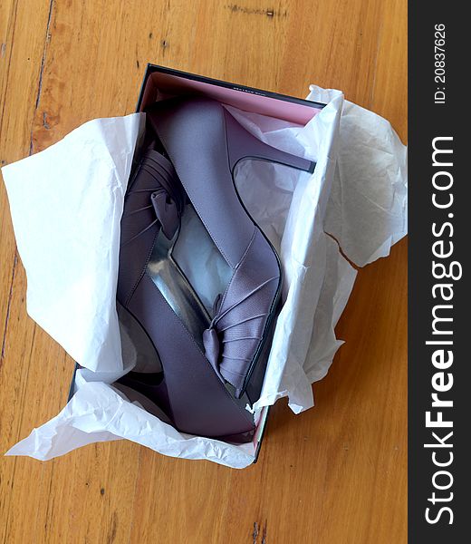 Ladies high heeled shoes in a shoe box