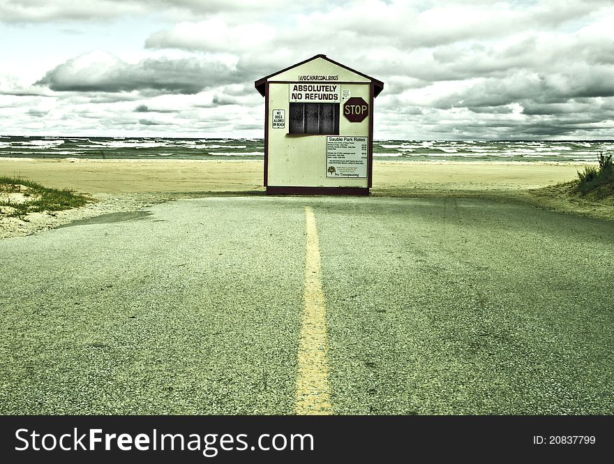 Toll booth where road ends on beach. Stormy weather.Manipulated image. Toll booth where road ends on beach. Stormy weather.Manipulated image.
