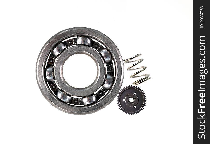 A bearing spring and gear against a white background. A bearing spring and gear against a white background