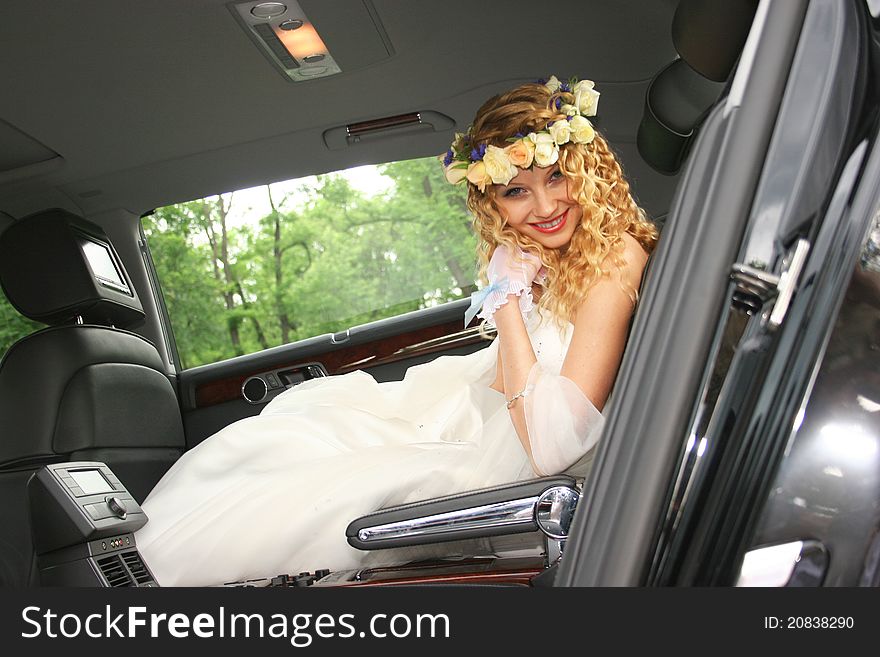 Bride sits in the car