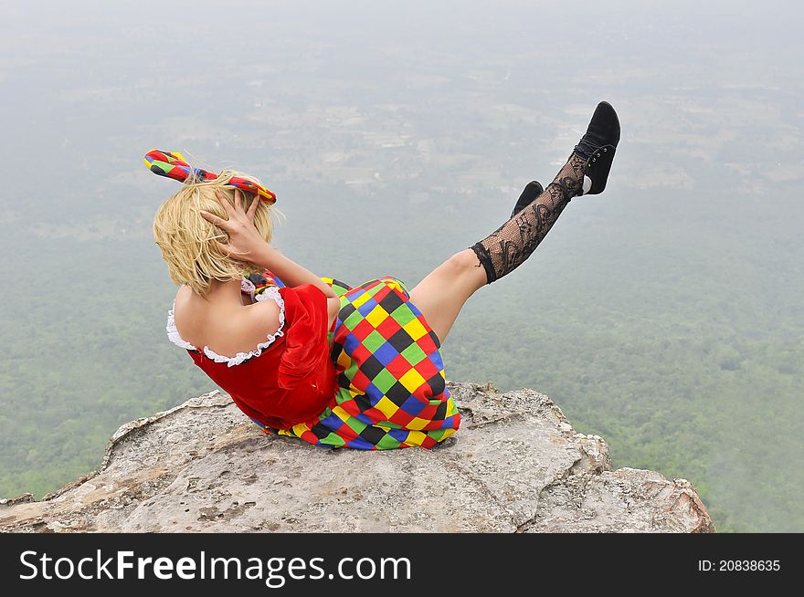 Young woman playing on the cliff