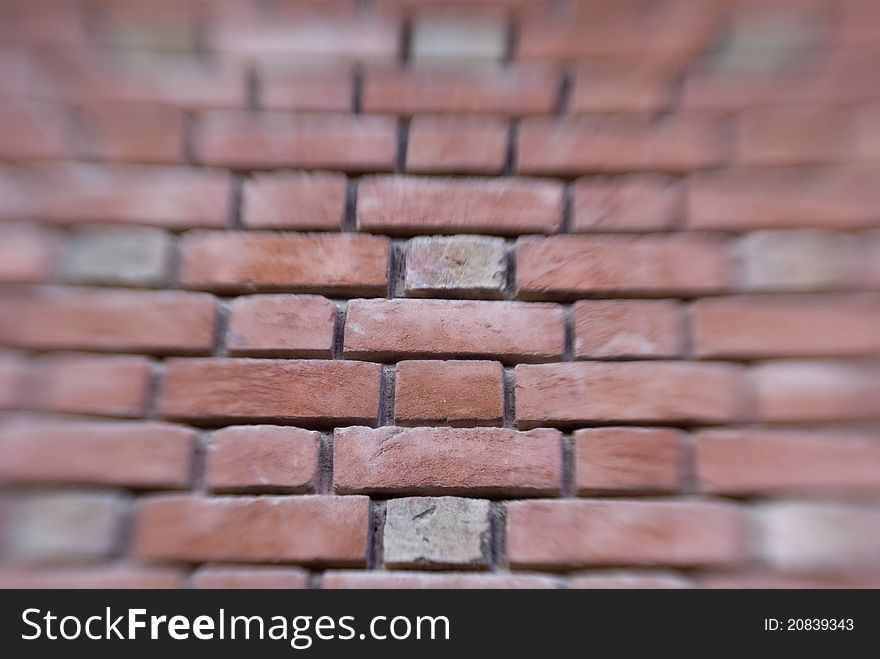 Blurred view of brick wall, center in focus. Blurred view of brick wall, center in focus.