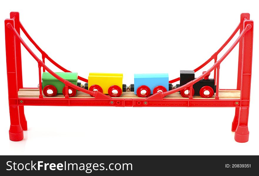 Colorful toy train on the red bridge