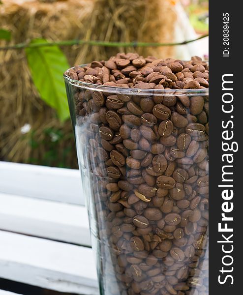 Glass jar with brown coffee beans. Glass jar with brown coffee beans