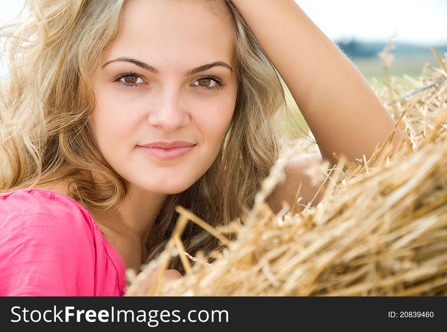 Girl at a stack of straw