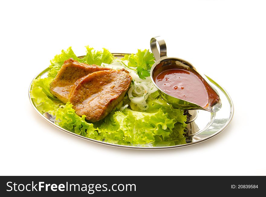 Pork with salad and sauce. Pork with salad and sauce