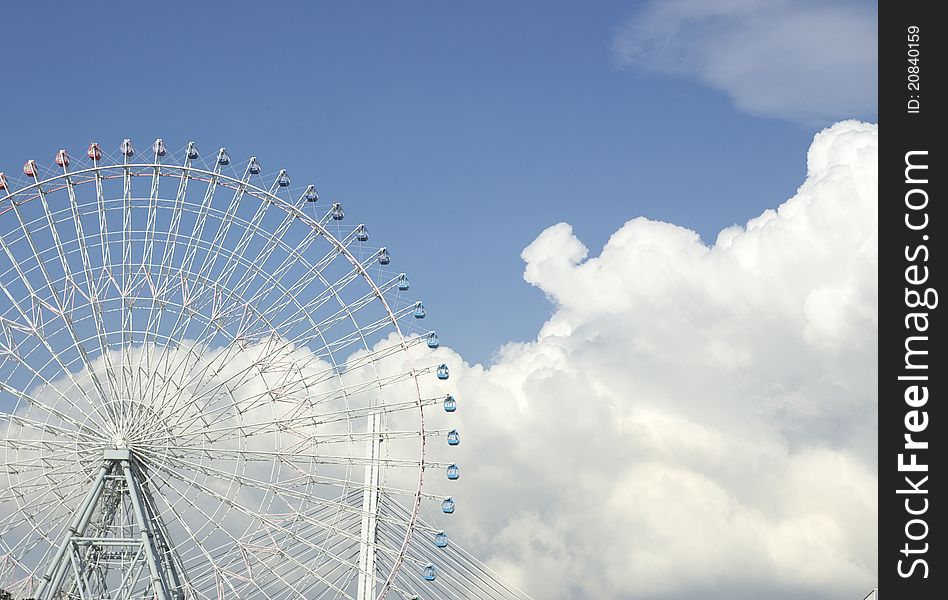 Blue sky, white clouds, ferris wheel