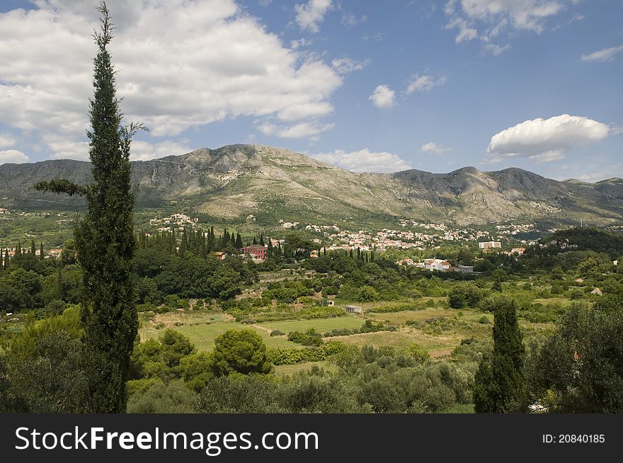 Croatia landscape with red roofs, mountains and blue sky