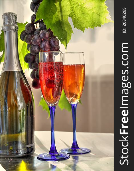 Red wine in glasses and grapes