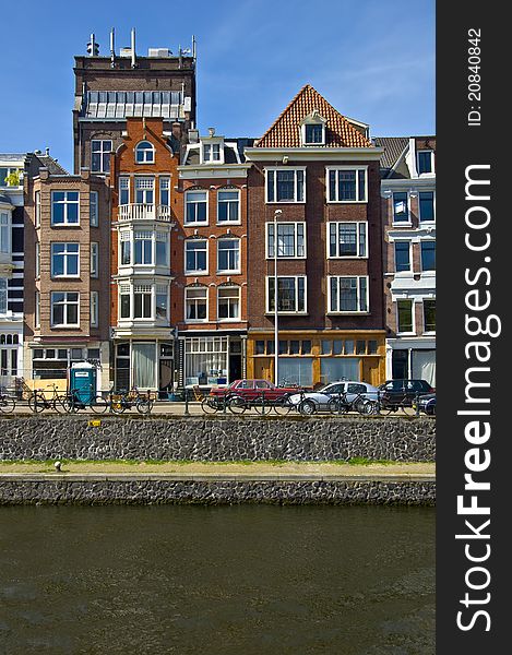 Classic amsterdam view. Residential homes on the canal. Urban scene. Spring.