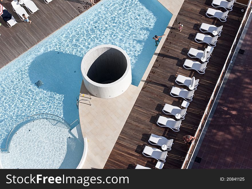 View from above of a particular outdoor swimming-pool. View from above of a particular outdoor swimming-pool