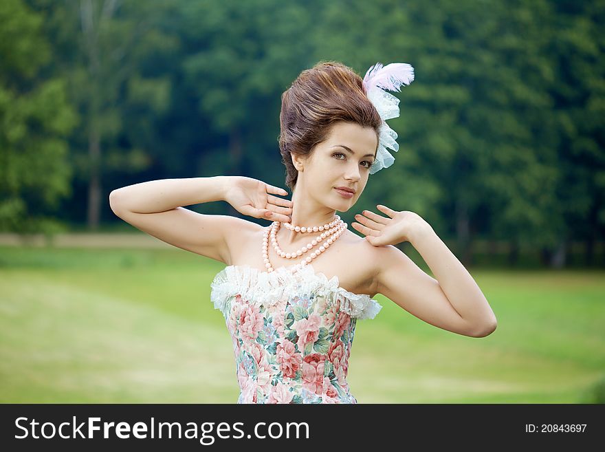 A woman like a princess in an vintage dress in nature