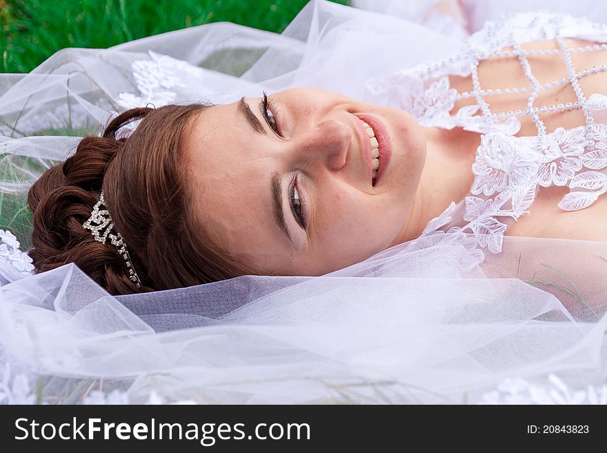 Portrait of a beautiful bride on the grass