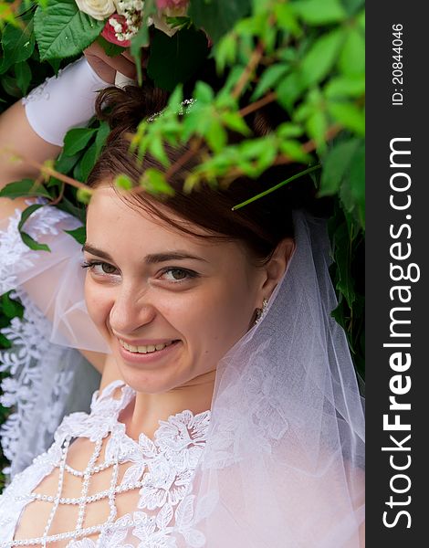 Portrait of a beautiful bride at green wall