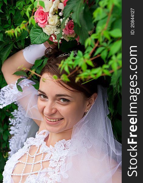 Portrait of a beautiful bride at green wall