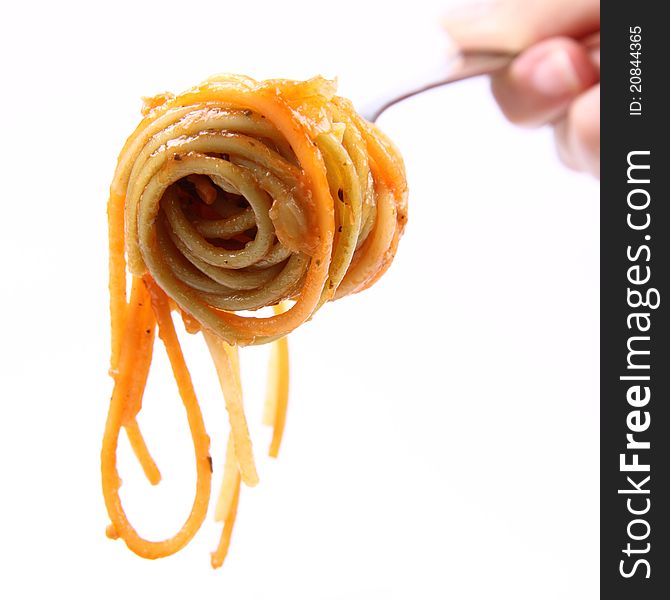 Spaghetti with sauce on a fork held by a woman's hand. Spaghetti with sauce on a fork held by a woman's hand