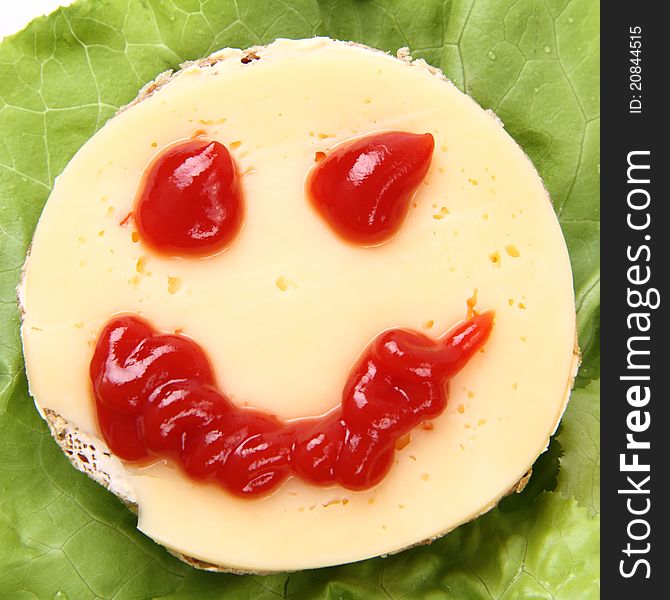 Smiling cheese sandwich for kids on lettuce