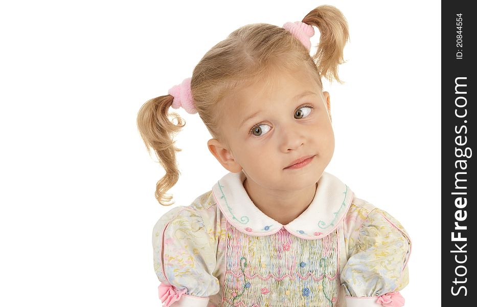 Surprise little girl with two tails wearing a dress on a white background