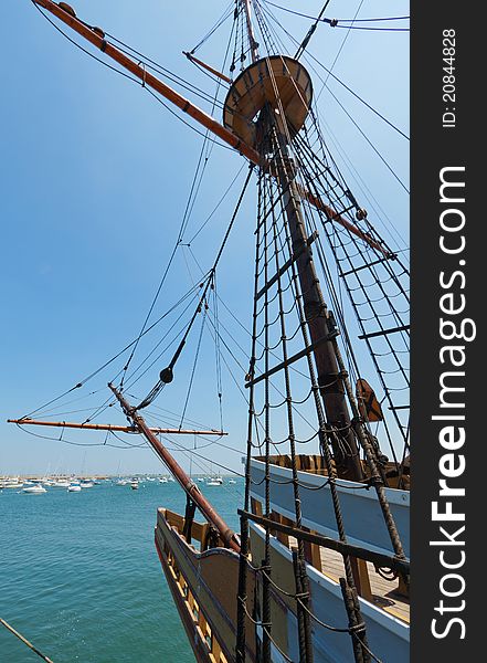 View of mast and rigging on the tall sail ship against the blue sky. View of mast and rigging on the tall sail ship against the blue sky.