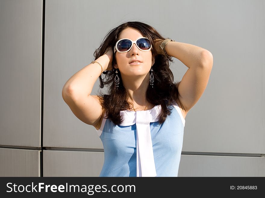 City girl in sunglasses posing outdoor