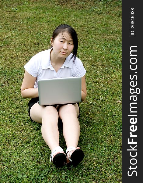 Girl working on laptop outdoor