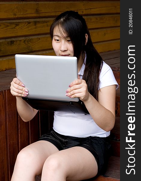 Girl working on laptop outdoor