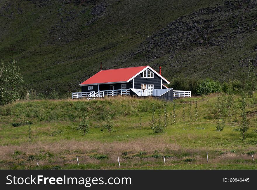 Black house with red roof and white trim in Iceland. Black house with red roof and white trim in Iceland