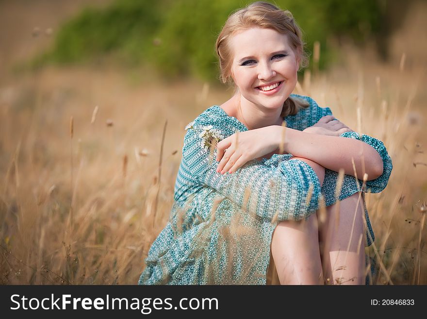 Beautiful woman relaxing in the straw in field. Beautiful woman relaxing in the straw in field