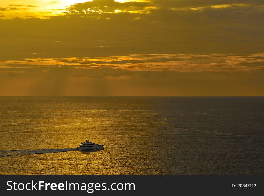 Boat on golden sea, Phromthep cape, Phuket, Thailand