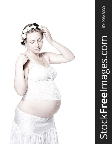 Lovely pregnant woman with flower wreath, high key. Lovely pregnant woman with flower wreath, high key