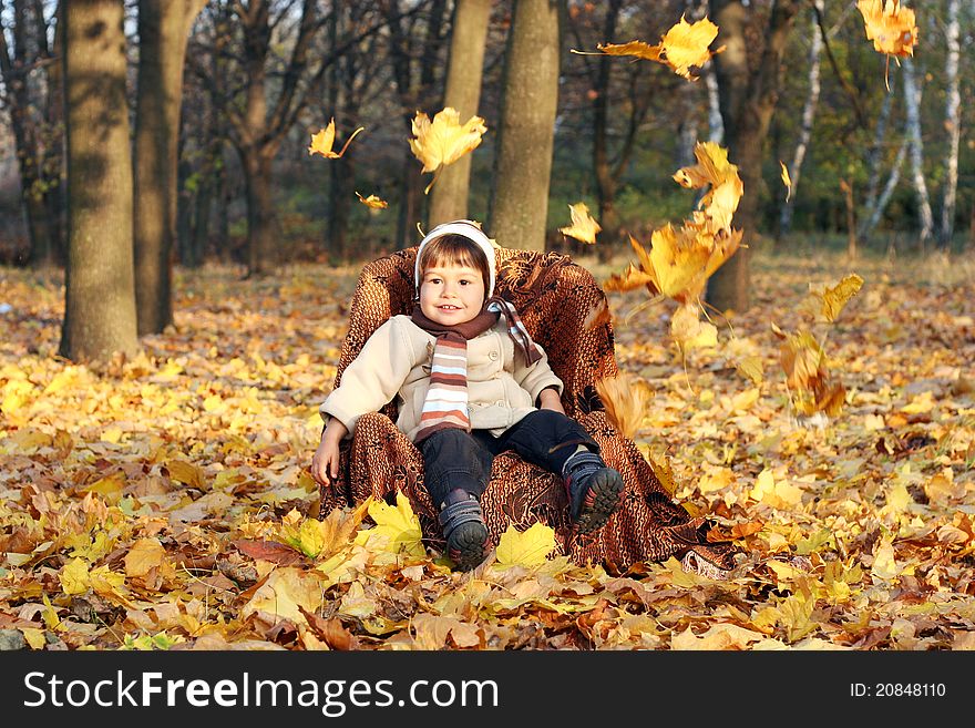 Little boy sitting in chair outdoors