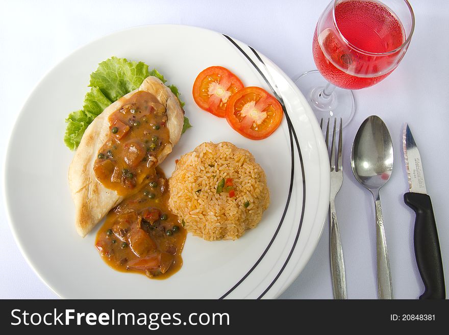 Chicken steak and fried rice with pepper brown sauce and a glass of pink wine. Chicken steak and fried rice with pepper brown sauce and a glass of pink wine