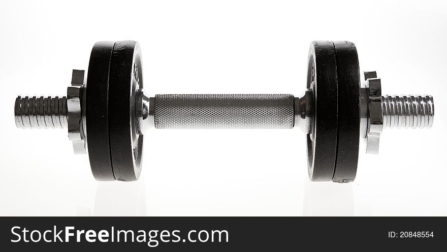 Metal dumbbell on white background. Studio shot