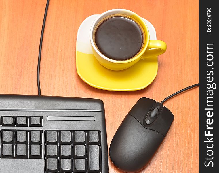 Computer mouse, black keyboard and coffee cup