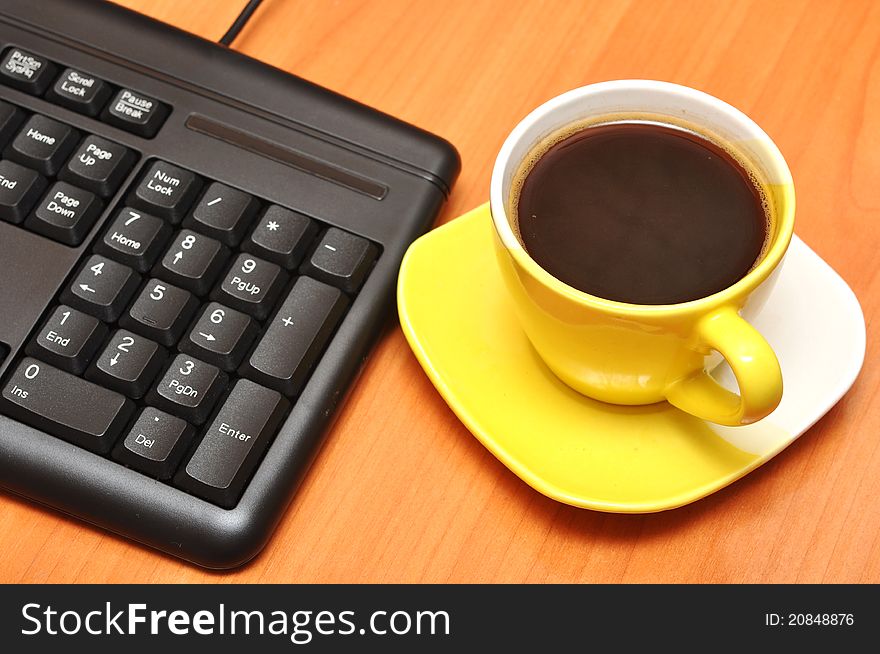 Empty keyboard and coffee cup. Empty keyboard and coffee cup