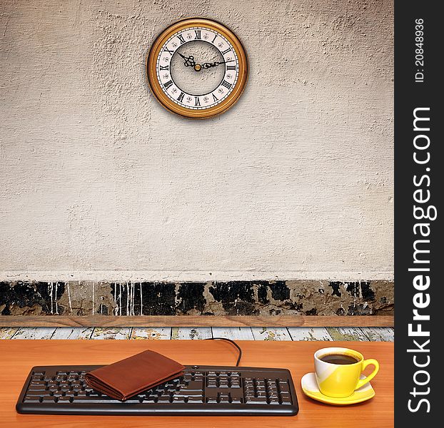 Room interior-keyboard on desk and a business clock on old wall. Room interior-keyboard on desk and a business clock on old wall