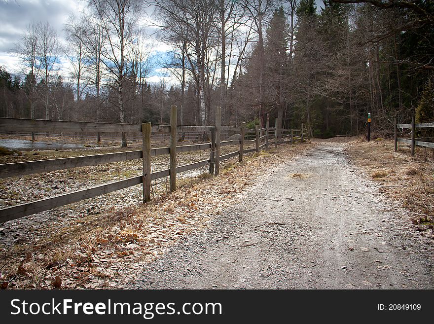 Wooden fence along a gravel path