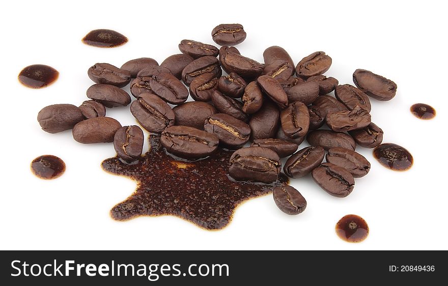 Grains of fried coffee and poured by coffee on a white background