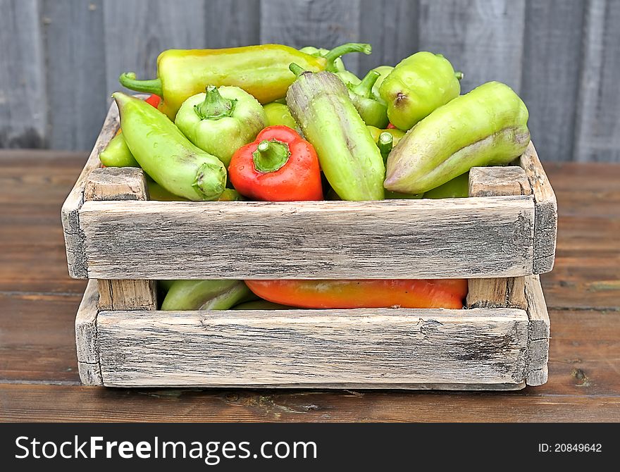 Peppers in a box on the table. Peppers in a box on the table.