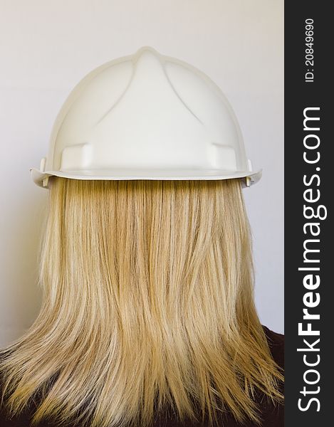 White hard hat reversed on womans head