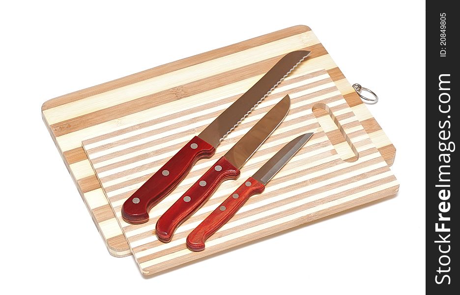 Kitchen knifes on board on white