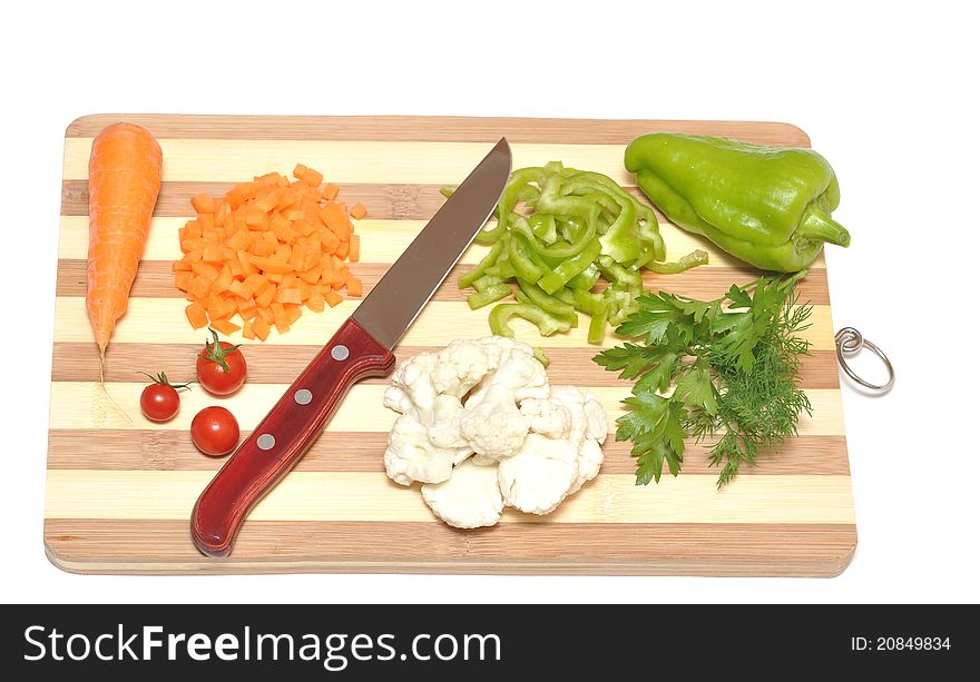 Still life of vegetables and kitchen-knife on cutting board