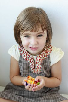 Little Girl With Candies In Her Hands Stock Photography Little Girl With Candies In Her Hands Stock Photography