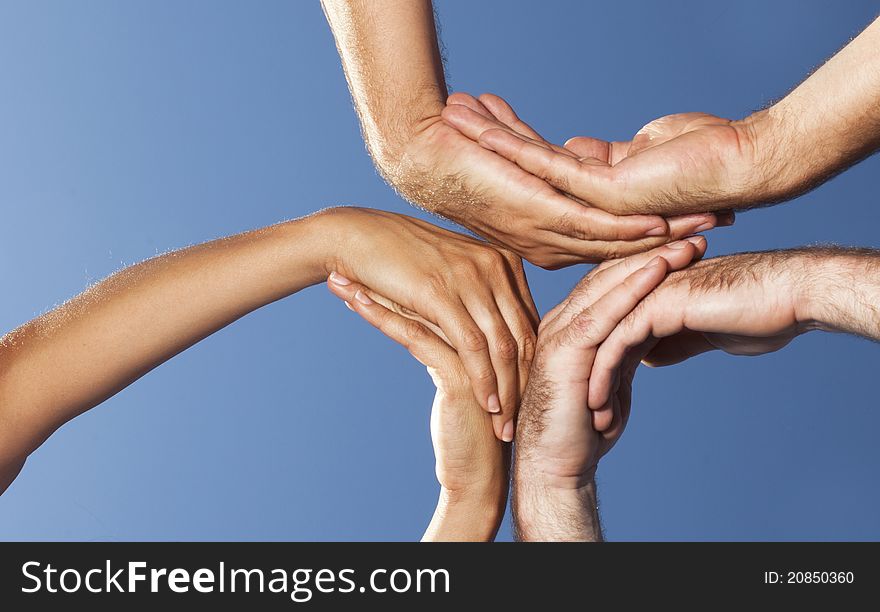 Three persons put their palms together. Three persons put their palms together