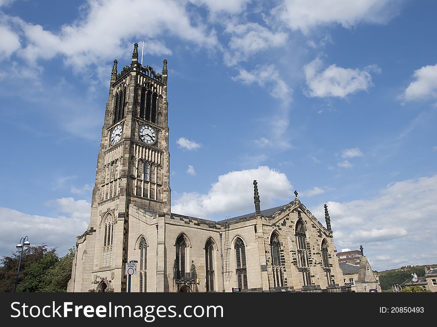 The Parish Church and Clocktower of a Yorkshire Town under a blue sky