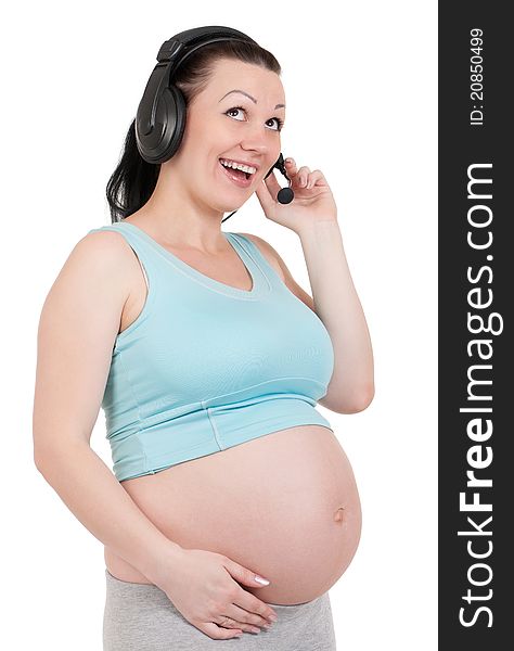 Pregnant with headphones - isolated over a white background. Third trimester.